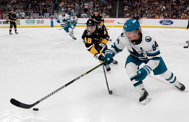 Mar 14, 2024; Pittsburgh, Pennsylvania, USA; San Jose Sharks center Mikael Granlund (64) reaches for the puck ahed of Pittsburgh Penguins right wing Valtteri Puustinen (48) during the second period at PPG Paints Arena. Mandatory Credit: Charles LeClaire-USA TODAY Sports