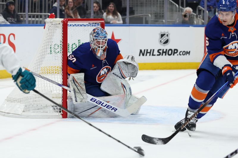 Jan 18, 2025; Elmont, New York, USA;  New York Islanders goaltender Marcus Hogberg (50) tracks the puck against the San Jose Sharks during the first period at UBS Arena. Mandatory Credit: Thomas Salus-Imagn Images