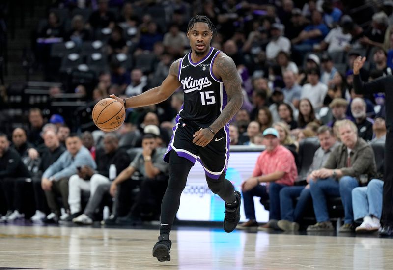 SACRAMENTO, CALIFORNIA - APRIL 11: Davion Mitchell #15 of the Sacramento Kings dribbles the ball against the New Orleans Pelicans during the second half of an NBA basketball game at Golden 1 Center on April 11, 2024 in Sacramento, California. NOTE TO USER: User expressly acknowledges and agrees that, by downloading and or using this photograph, User is consenting to the terms and conditions of the Getty Images License Agreement. (Photo by Thearon W. Henderson/Getty Images)