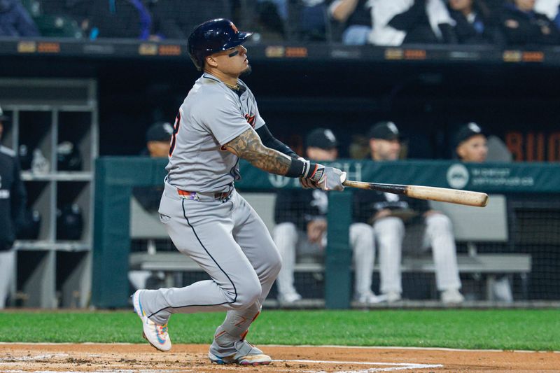Jun 4, 2025; Chicago, Illinois, USA; Detroit Tigers center fielder Javier Báez (28) hits an RBI-single against the Chicago White Sox during the first inning at Rate Field. Mandatory Credit: Kamil Krzaczynski-Imagn Images
