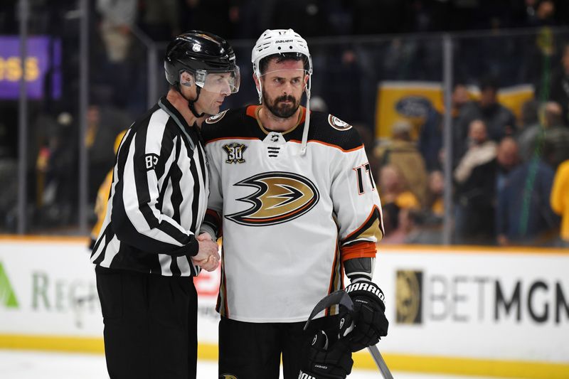 Jan 9, 2024; Nashville, Tennessee, USA; Anaheim Ducks left wing Alex Killorn (17) shakes hands with linesman Ryan Galloway (82) after the game against the Nashville Predators at Bridgestone Arena. Mandatory Credit: Christopher Hanewinckel-USA TODAY Sports