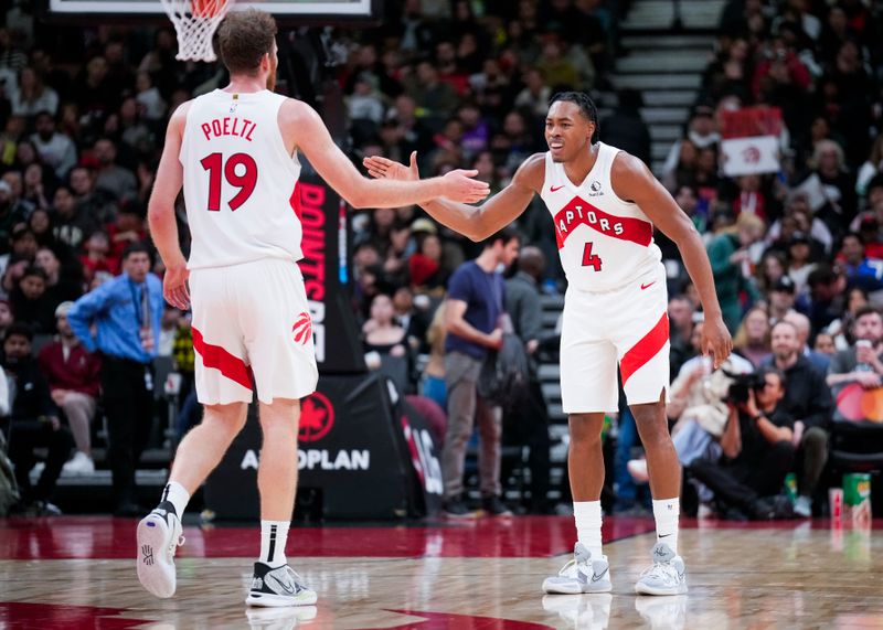 TORONTO, ON - OCTOBER 15: Scottie Barnes #4 and Jakob Poeltl #19 of the Toronto Raptors celebrate against the Boston Celtics during the second half of their preseason basketball game at the Scotiabank Arena on October 15, 2024 in Toronto, Ontario, Canada. NOTE TO USER: User expressly acknowledges and agrees that, by downloading and/or using this Photograph, user is consenting to the terms and conditions of the Getty Images License Agreement. (Photo by Mark Blinch/Getty Images)