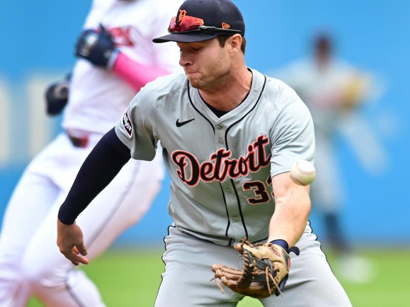 Jul 25, 2024; Cleveland, Ohio, USA; Detroit Tigers second baseman Colt Keith (33) bobbles the relay throw from the outfield after Cleveland Guardians right fielder Jhonkensy Noel, rear, hit a double during the second inning against the Detroit Tigers at Progressive Field. Mandatory Credit: Ken Blaze-USA TODAY Sports