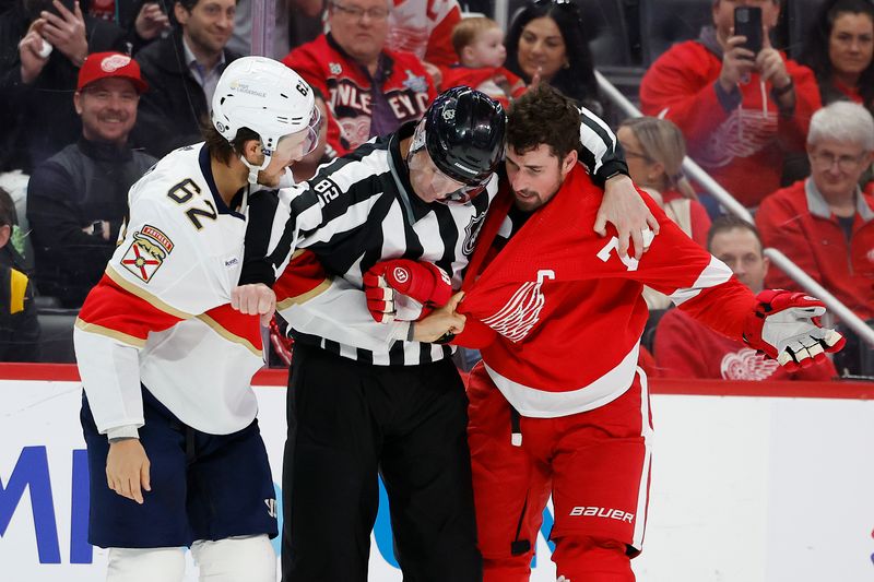 Mar 2, 2024; Detroit, Michigan, USA; Linesman Ryan Galloway (82) gets between Detroit Red Wings center Dylan Larkin (71) and Florida Panthers defenseman Brandon Montour (62) in the third period at Little Caesars Arena. Mandatory Credit: Rick Osentoski-USA TODAY Sports