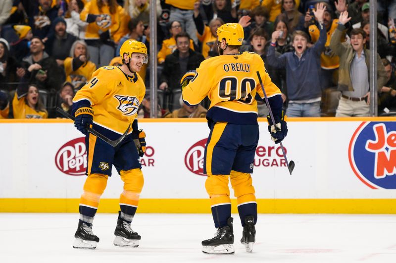 Nov 27, 2024; Nashville, Tennessee, USA;  Nashville Predators center Ryan O'Reilly (90) celebrates after his goal with center Gustav Nyquist (14) against the Philadelphia Flyers during the first period at Bridgestone Arena. Mandatory Credit: Steve Roberts-Imagn Images