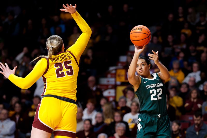 Jan 20, 2024; Minneapolis, Minnesota, USA; Michigan State Spartans guard Moira Joiner (22) shoots as Minnesota Golden Gophers guard Grace Grocholski (25) defends during the second half at Williams Arena. Mandatory Credit: Matt Krohn-USA TODAY Sports