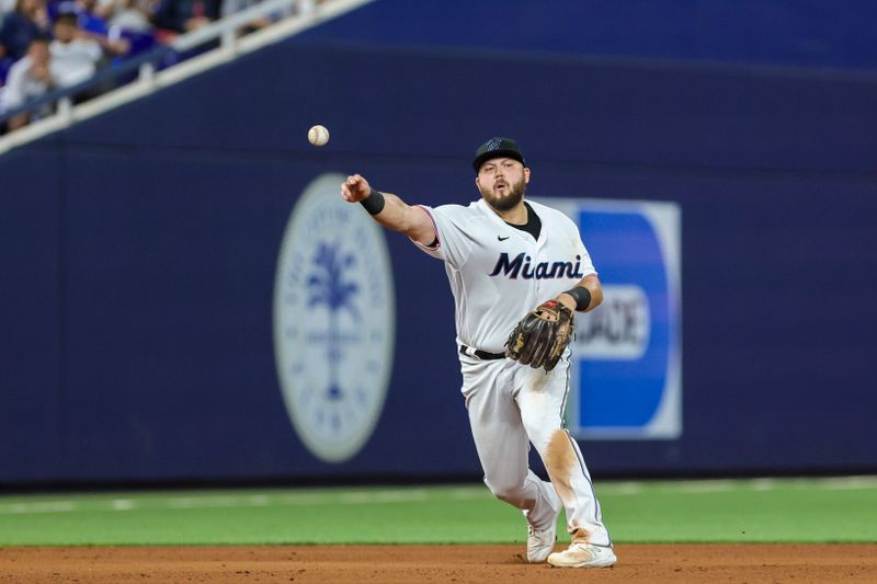 Aug 15, 2023; Miami, Florida, USA; Miami Marlins third baseman Jake Burger (36) throws to first and retires Houston Astros shortstop Jeremy Pena (not pictured) during the eighth inning at loanDepot Park. Mandatory Credit: Sam Navarro-USA TODAY Sports