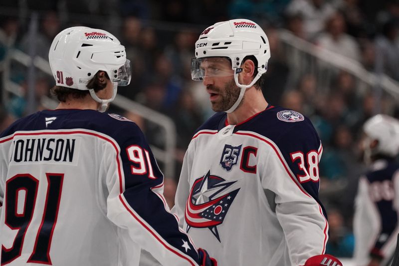 Jan 6, 2026; San Jose, California, USA;  Columbus Blue Jackets center Kent Johnson (91) and Columbus Blue Jackets center Boone Jenner (38) talk during a break in the action against the San Jose Sharks in the third period at SAP Center at San Jose. Mandatory Credit: David Gonzales-Imagn Images