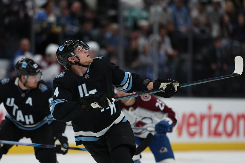 Oct 24, 2024; Salt Lake City, Utah, USA; Utah Hockey Club right wing Dylan Guenther (11) looks for the puck against the Colorado Avalanche during the first period at Delta Center. Mandatory Credit: Rob Gray-Imagn Images