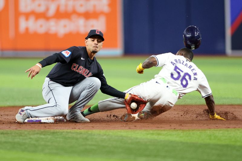 Jul 12, 2024; St. Petersburg, Florida, USA; Tampa Bay Rays outfielder Randy Arozarena (56) steals second base from Cleveland Guardians second baseman Andres Gimenez (0) in the third inning at Tropicana Field. Mandatory Credit: Nathan Ray Seebeck-USA TODAY Sports