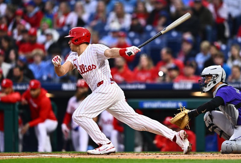 Apr 17, 2024; Philadelphia, Pennsylvania, USA; Philadelphia Phillies catcher J.T. Realmuto (10) hits a single against the Colorado Rockies in the first inning at Citizens Bank Park. Mandatory Credit: Kyle Ross-USA TODAY Sports