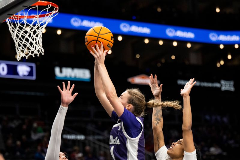 Mar 7, 2025; Kansas City, MO, USA; Kansas State Wildcats guard Serena Sundell (4) shoos the ball against the West Virginia Mountaineers in the fourth quarter at T-Mobile Center. Mandatory Credit: Amy Kontras-Imagn Images