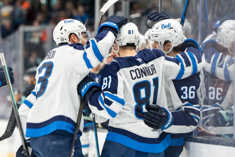 Mar 16, 2025; Seattle, Washington, USA;  Winnipeg Jets forward Kyle Connor (81) celebrates after scoring a goal with forward Gabriel Vilardi (13) and forward Morgan Barron (36) during the second period against the Seattle Kraken at Climate Pledge Arena. Mandatory Credit: Stephen Brashear-Imagn Images