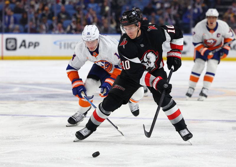 Nov 1, 2024; Buffalo, New York, USA;  Buffalo Sabres defenseman Henri Jokiharju (10) goes after a loose puck as New York Islanders center Bo Horvat (14) defends during the third period at KeyBank Center. Mandatory Credit: Timothy T. Ludwig-Imagn Images