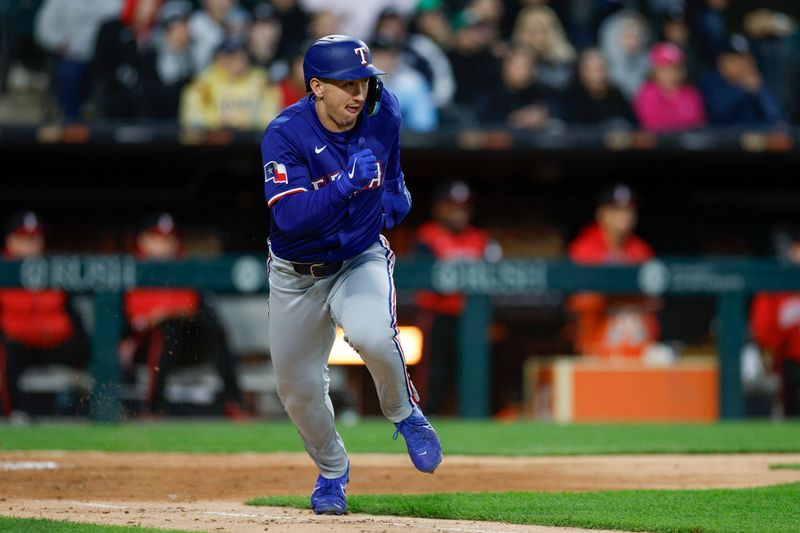 May 23, 2025; Chicago, Illinois, USA; Texas Rangers left fielder Wyatt Langford (36) runs after hitting a single against the Chicago White Sox during the sixth inning at Rate Field. Mandatory Credit: Kamil Krzaczynski-Imagn Images