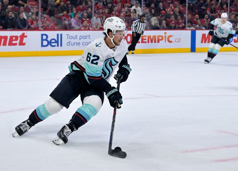 Oct 14, 2025; Montreal, Quebec, CAN; Seattle Kraken defenseman Brandon Montour (62) plays the puck against the Montreal Canadiens during the second period at the Bell Centre. Mandatory Credit: Eric Bolte-Imagn Images