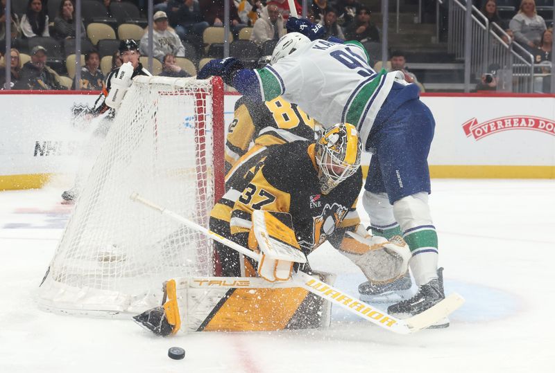 Oct 21, 2025; Pittsburgh, Pennsylvania, USA;  Pittsburgh Penguins goaltender Arturs Silovs (37) makes a save against Vancouver Canucks left wing Evander Kane (91) during the first period at PPG Paints Arena. Mandatory Credit: Charles LeClaire-Imagn Images
