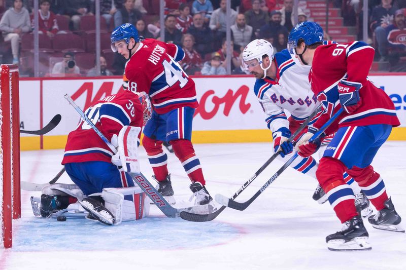 Oct 22, 2024; Ottawa, Ontario, CAN; Montreal Canadiens goalie Cayden Primeau (30) makes a save in front of New York Rangers center Sam Carrick (39) in the third period at the Bell Centre. Mandatory Credit: Marc DesRosiers-Imagn Images