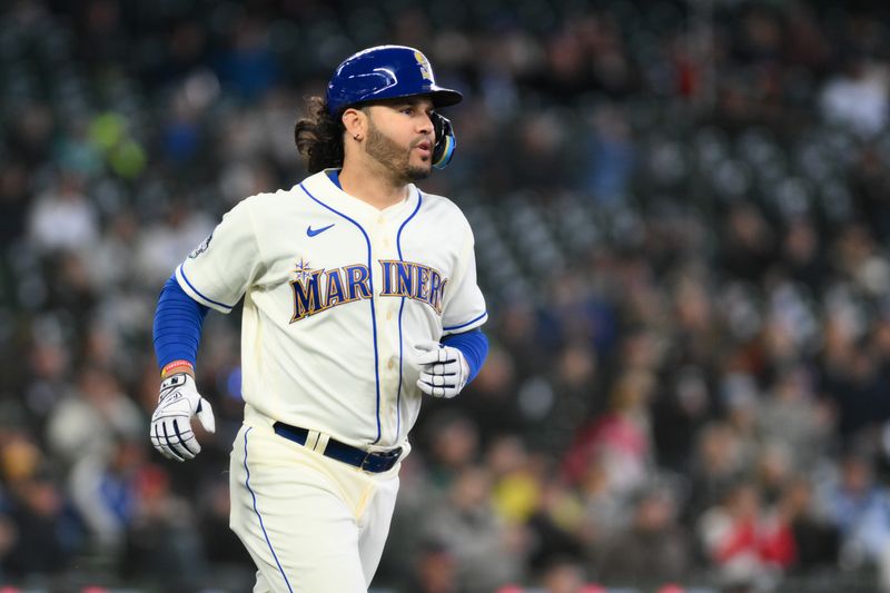 Apr 16, 2023; Seattle, Washington, USA; Seattle Mariners third baseman Eugenio Suarez (28) runs towards first bast after hitting a single against the Colorado Rockies during the fourth inning at T-Mobile Park. Mandatory Credit: Steven Bisig-USA TODAY Sports