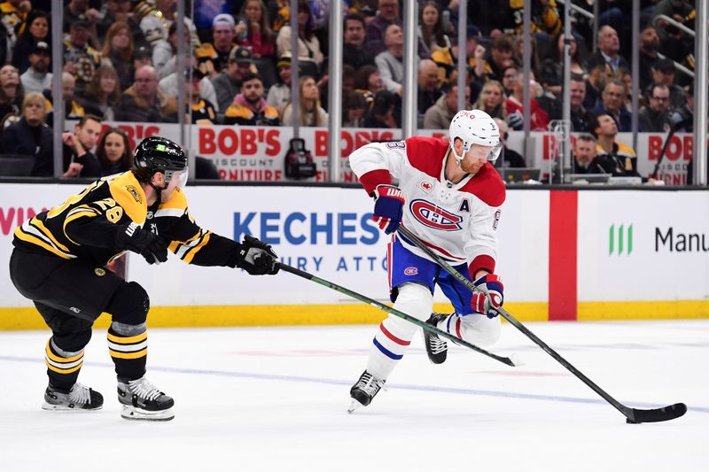 Oct 10, 2024; Boston, Massachusetts, USA; Montreal Canadiens defenseman Mike Matheson (8) controls the puck in front of Boston Bruins center Elias Lindholm (28) during the second period at TD Garden. Mandatory Credit: Bob DeChiara-Imagn Images