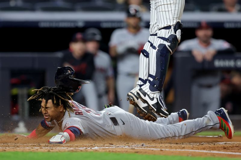 Jun 3, 2025; Bronx, New York, USA; Cleveland Guardians third baseman Jose Ramirez (11) slides home against the New York Yankees on an RBI single by designated hitter David Fry (not pictured) during the seventh inning at Yankee Stadium. Mandatory Credit: Brad Penner-Imagn Images