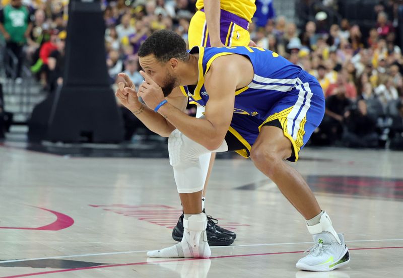 LAS VEGAS, NEVADA - OCTOBER 15: Stephen Curry #30 of the Golden State Warriors mimics fans taking photos of his shoe after it came off at the start of a preseason game against the Los Angeles Lakers at T-Mobile Arena at T-Mobile Arena on October 15, 2024 in Las Vegas, Nevada. NOTE TO USER: User expressly acknowledges and agrees that, by downloading and or using this photograph, User is consenting to the terms and conditions of the Getty Images License Agreement. (Photo by Ethan Miller/Getty Images)