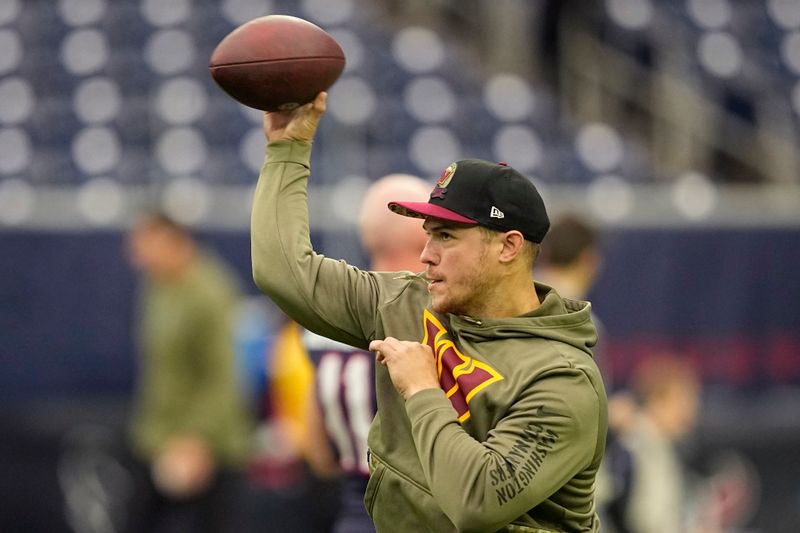 Washington Commanders quarterback Taylor Heinicke (4) warms up before an NFL football game against the Houston Texans, Sunday, Nov. 20, 2022, in Houston. (AP Photo/David J. Phillip Phillip STF AP)