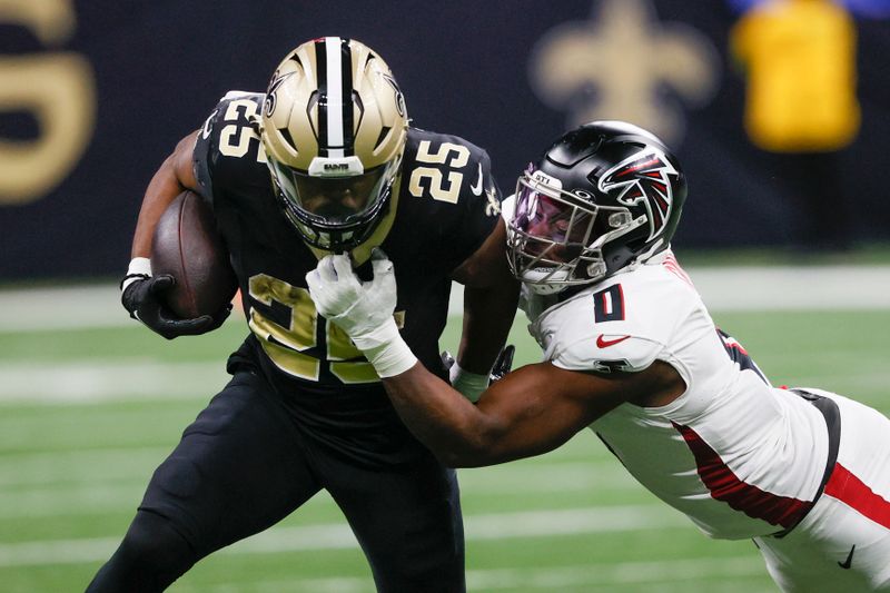 New Orleans Saints running back Kendre Miller (25) carries the ball as Atlanta Falcons linebacker Lorenzo Carter (0) makes a tackle in the second half of an NFL football game in New Orleans, Sunday, Jan. 7, 2024. (AP Photo/Butch Dill)