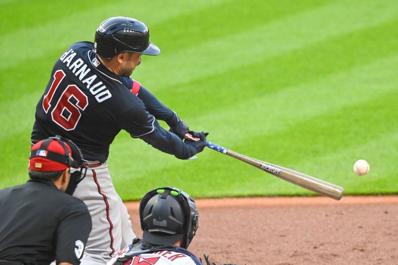 Jul 4, 2023; Cleveland, Ohio, USA; Atlanta Braves catcher Travis d'Arnaud (16) hits an RBI single in the fifth inning against the Cleveland Guardians at Progressive Field. Mandatory Credit: David Richard-USA TODAY Sports