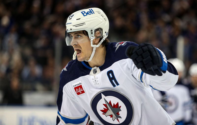 Mar 19, 2024; New York, New York, USA; Winnipeg Jets center Mark Scheifele (55) celebrates his second goal of the night against the New York Rangers during the second period at Madison Square Garden. Mandatory Credit: Danny Wild-USA TODAY Sports