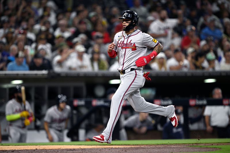 Jul 12, 2024; San Diego, California, USA; Atlanta Braves shortstop Orlando Arcia (11) scores a run on a sacrifice fly hit by third baseman Austin Riley (not pictured) during the eighth inning against the San Diego Padres at Petco Park. Mandatory Credit: Orlando Ramirez-USA TODAY Sports 