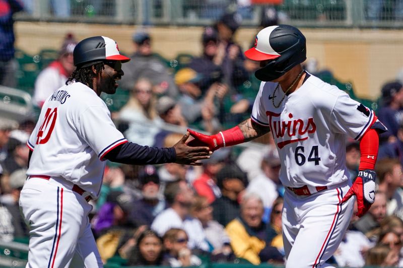 Apr 26, 2023; Minneapolis, Minnesota, USA; Minnesota Twins designated hitter Jose Miranda (64) celebrates his two-run home run against the New York Yankees with third base coach Tommy Watkins (40) during the fourth inning at Target Field. Mandatory Credit: Nick Wosika-USA TODAY Sports

