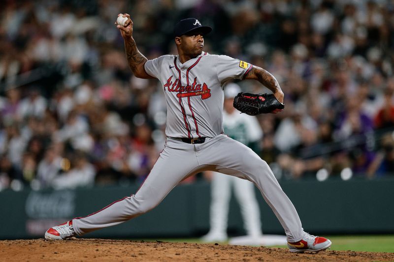 Aug 10, 2024; Denver, Colorado, USA; Atlanta Braves relief pitcher Raisel Iglesias (26) pitches in the ninth inning against the Colorado Rockies at Coors Field. Mandatory Credit: Isaiah J. Downing-USA TODAY Sports