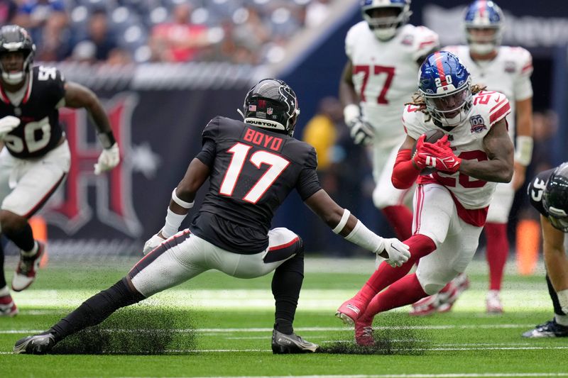 New York Giants running back Eric Gray (20) finds running room as Houston Texans cornerback Kris Boyd (17) defends in the second half of a preseason NFL football game, Saturday, Aug. 17, 2024, in Houston. (AP Photo/Eric Gay)