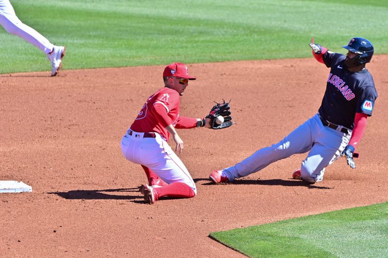 Feb 29, 2024; Tempe, Arizona, USA;  Cleveland Guardians second baseman Juan Brito (74) is tagged out by Los Angeles Angels shortstop Zach Neto (9) while stealing a base in the third inning during a spring training game at Tempe Diablo Stadium. Mandatory Credit: Matt Kartozian-USA TODAY Sports