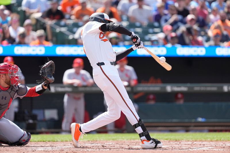 May 26, 2025; Baltimore, Maryland, USA; Baltimore Orioles center fielder Dylan Carlson (15) hits a single against the St. Louis Cardinals during the third inning at Oriole Park at Camden Yards. Mandatory Credit: Gregory Fisher-Imagn Images