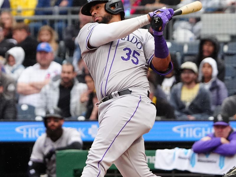 May 4, 2024; Pittsburgh, Pennsylvania, USA; Colorado Rockies catcher Elias Diaz (35) hits a double against the Pittsburgh Pirates during the fifth inning at PNC Park. Mandatory Credit: Gregory Fisher-USA TODAY Sports