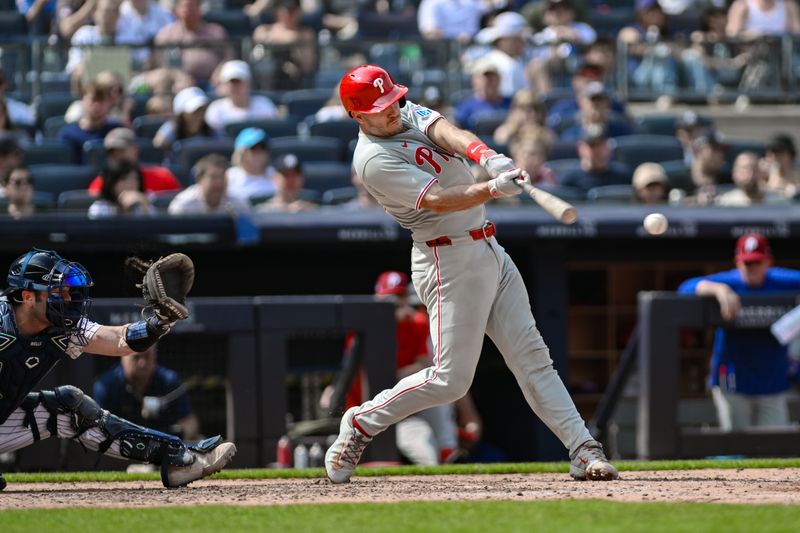 Jul 27, 2025; Bronx, New York, USA; Philadelphia Phillies catcher J.T. Realmuto (10) hits a single against the New York Yankees during the sixth inning at Yankee Stadium. Mandatory Credit: John Jones-Imagn Images