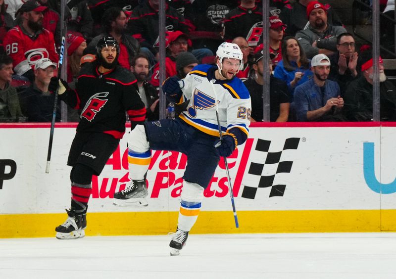 Jan 6, 2024; Raleigh, North Carolina, USA; St. Louis Blues left wing Nathan Walker (26) celebrates his goal against the Carolina Hurricanes during the first period at PNC Arena. Mandatory Credit: James Guillory-USA TODAY Sports