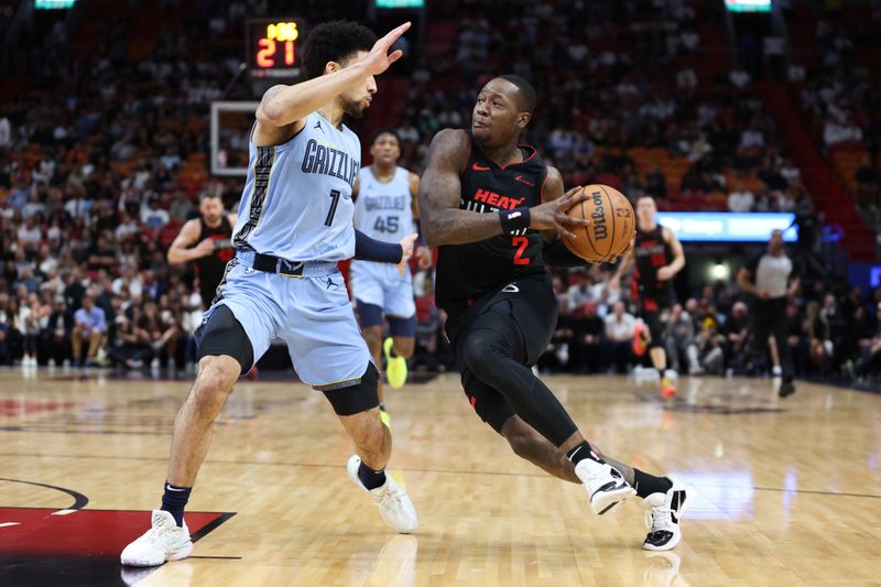 MIAMI, FLORIDA - JANUARY 24: Terry Rozier #2 of the Miami Heat drives against Scotty Pippen Jr. #1 of the Memphis Grizzlies during the second quarter of the game at Kaseya Center on January 24, 2024 in Miami, Florida. NOTE TO USER: User expressly acknowledges and agrees that, by downloading and or using this photograph, User is consenting to the terms and conditions of the Getty Images License Agreement. (Photo by Megan Briggs/Getty Images)