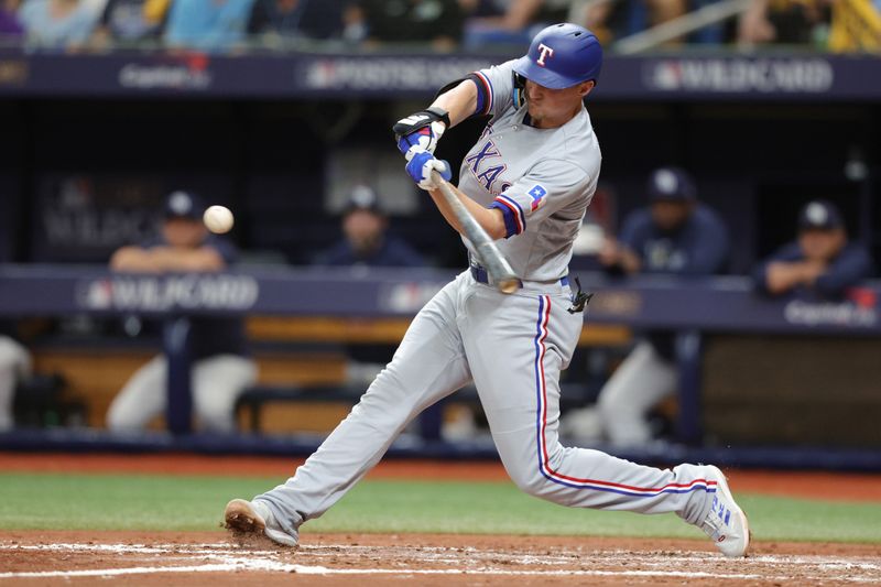 Oct 4, 2023; St. Petersburg, Florida, USA; Texas Rangers shortstop Corey Seager (5) bats against the Tampa Bay Rays in the fifth inning during game two of the Wildcard series for the 2023 MLB playoffs at Tropicana Field. Mandatory Credit: Nathan Ray Seebeck-USA TODAY Sports