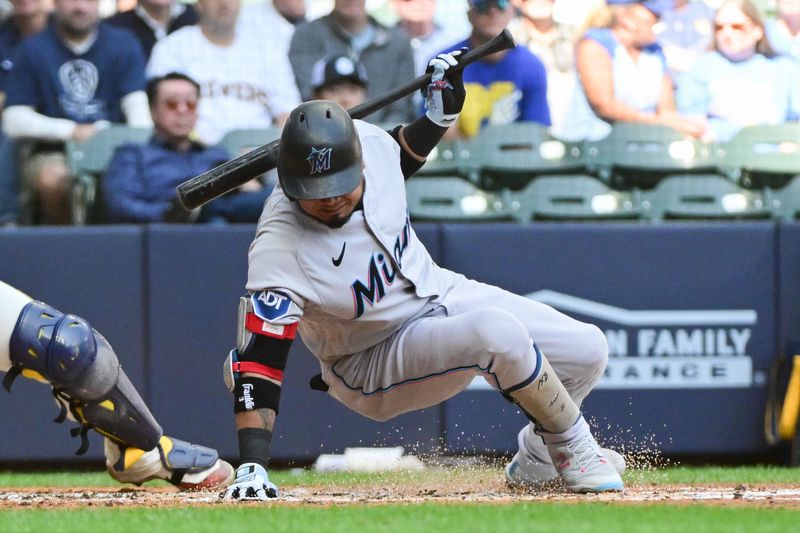 Sep 14, 2023; Milwaukee, Wisconsin, USA; Miami Marlins first baseman Luis Arraez (3) avoids getting hit by a pitch in the fourth inning against the Milwaukee Brewers at American Family Field. Mandatory Credit: Benny Sieu-USA TODAY Sports