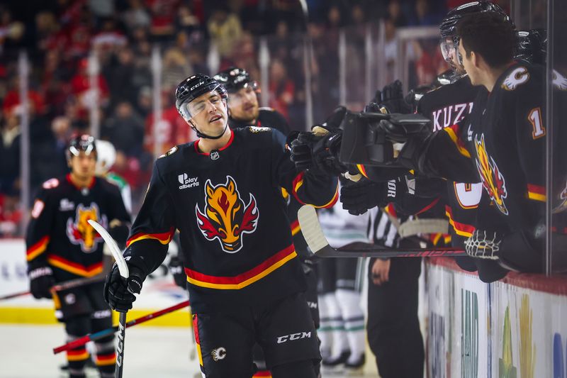 Mar 3, 2026; Calgary, Alberta, CAN; Calgary Flames center Morgan Frost (16) celebrates his goal with teammates against the Dallas Stars during the first period at Scotiabank Saddledome. Mandatory Credit: Sergei Belski-Imagn Images