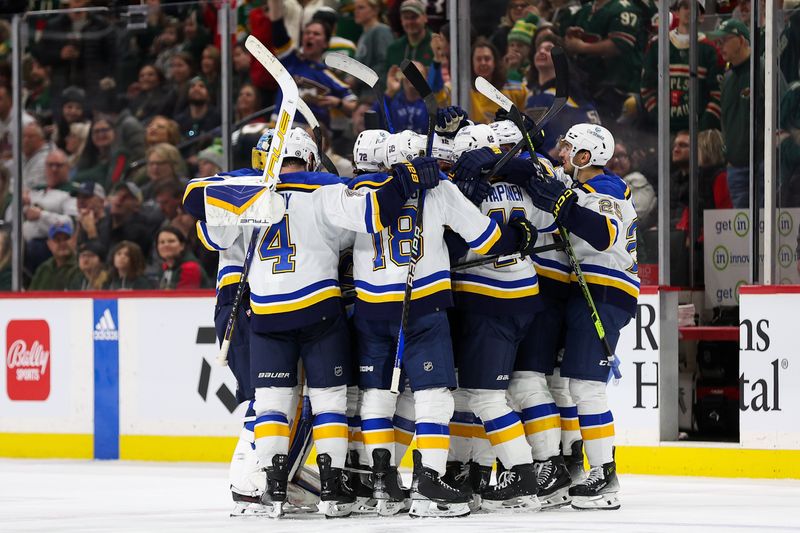 Mar 23, 2024; Saint Paul, Minnesota, USA; St. Louis Blues players celebrate the win against the Minnesota Wild during overtime at Xcel Energy Center. Mandatory Credit: Matt Krohn-USA TODAY Sports