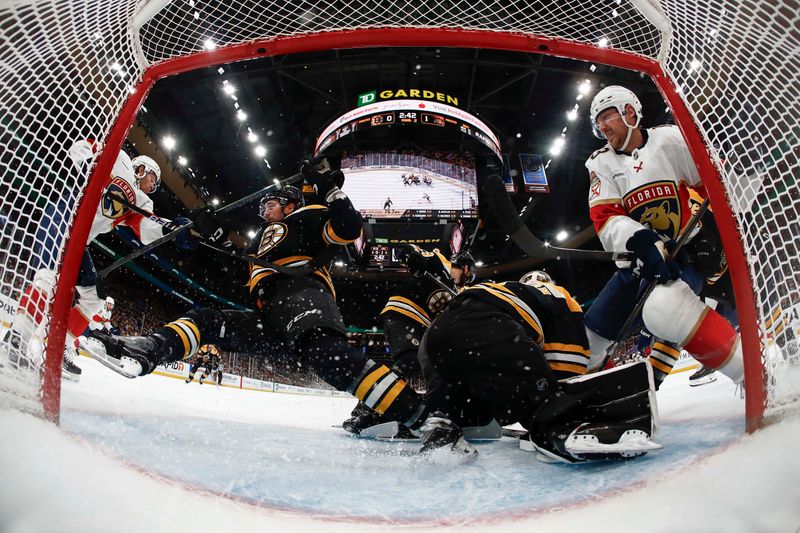 Mar 11, 2025; Boston, Massachusetts, USA; Florida Panthers center Carter Verhaeghe (23) (left) dumps Boston Bruins defenseman Andrew Peeke (52) in the crease during the third period at TD Garden. Mandatory Credit: Winslow Townson-Imagn Images