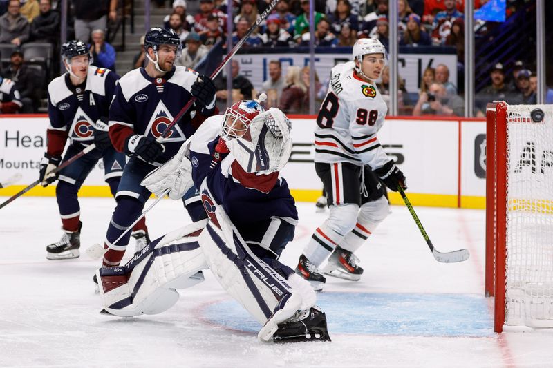 Oct 28, 2024; Denver, Colorado, USA; Colorado Avalanche goaltender Alexandar Georgiev (40) reaches for the puck as defenseman Devon Toews (7) and defenseman Cale Makar (8) and center Connor Bedard (98) look on in the third period at Ball Arena. Mandatory Credit: Isaiah J. Downing-Imagn Images