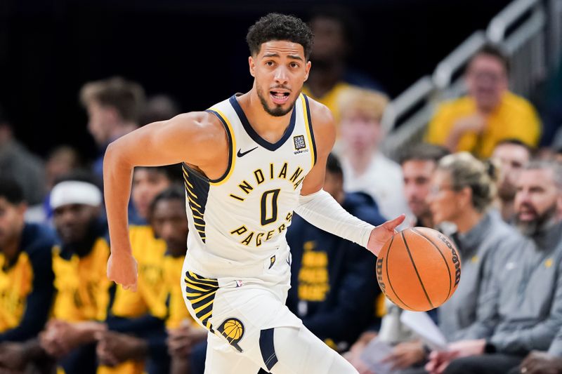 INDIANAPOLIS, INDIANA - OCTOBER 17: Tyrese Haliburton #0 of the Indiana Pacers dribbles the ball in the third quarter against the Charlotte Hornets during a preseason game at Gainbridge Fieldhouse on October 17, 2024 in Indianapolis, Indiana. NOTE TO USER: User expressly acknowledges and agrees that, by downloading and or using this photograph, User is consenting to the terms and conditions of the Getty Images License Agreement. (Photo by Dylan Buell/Getty Images)