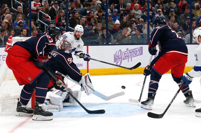 Nov 21, 2024; Columbus, Ohio, USA; Columbus Blue Jackets goalie Elvis Merzlikins (90) deflects the pass attempts of Tampa Bay Lightning right wing Nikita Kucherov during the third period at Nationwide Arena. Mandatory Credit: Russell LaBounty-Imagn Images