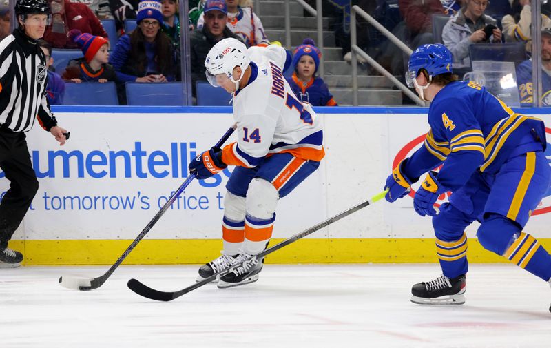 Mar 14, 2024; Buffalo, New York, USA;  New York Islanders center Bo Horvat (14) controls the puck as Buffalo Sabres defenseman Bowen Byram (4) defends during the first period at KeyBank Center. Mandatory Credit: Timothy T. Ludwig-USA TODAY Sports