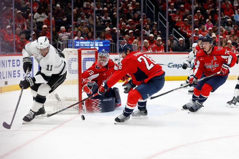 Nov 17, 2025; Washington, District of Columbia, USA; Los Angeles Kings center Anze Kopitar (11) and Washington Capitals center Nic Dowd (26) battle for the puck in front of Capitals goaltender Charlie Lindgren (79) during the second period at Capital One Arena. Mandatory Credit: Geoff Burke-Imagn Images